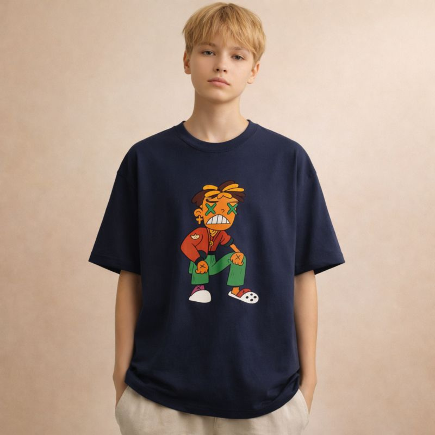 Androgynous model wearing a navy oversized cartoon graphic t-shirt with colorful streetwear character on beige studio background