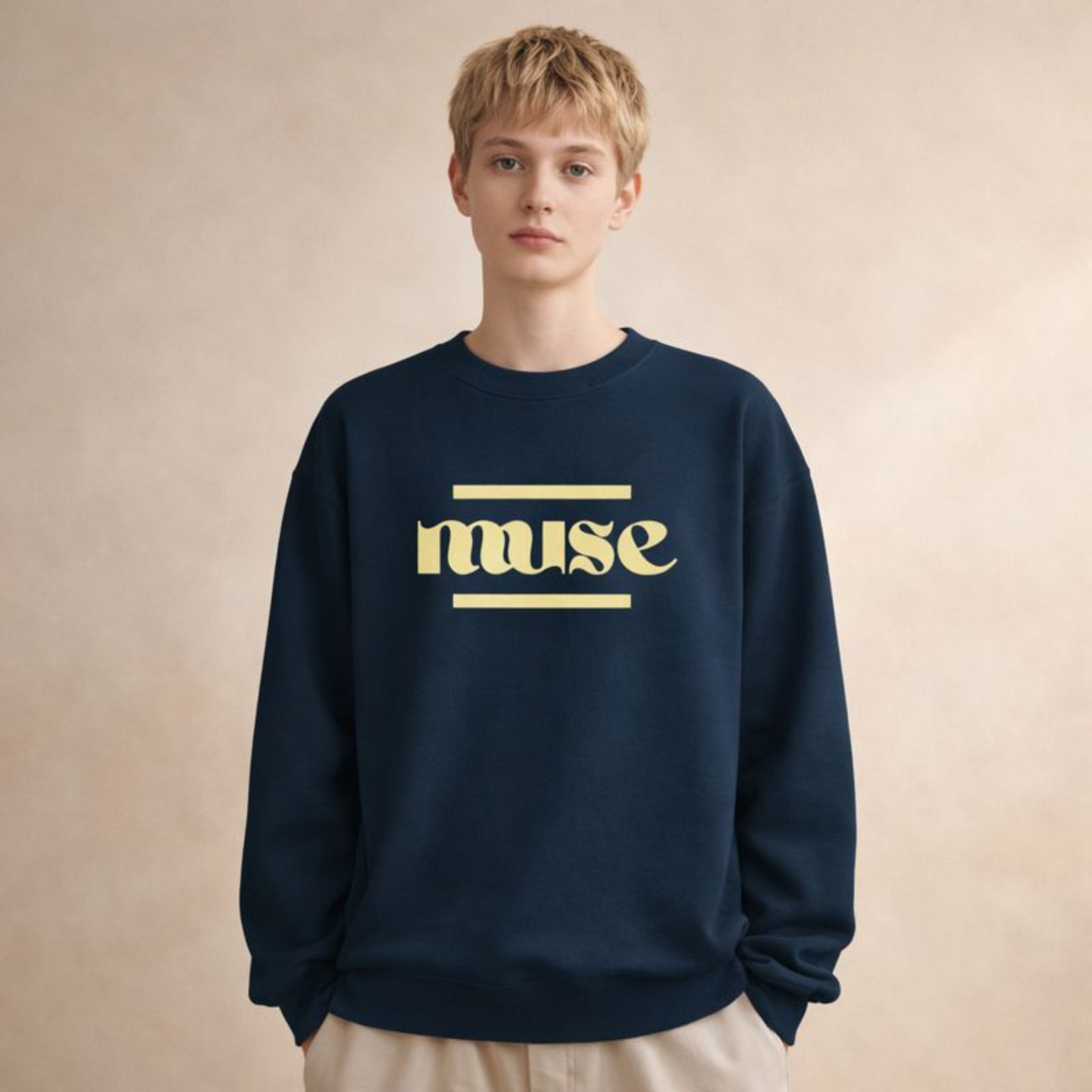 Navy unisex crewneck sweatshirt with “muse” minimalist typography, relaxed fit studio shot on soft beige backdrop.