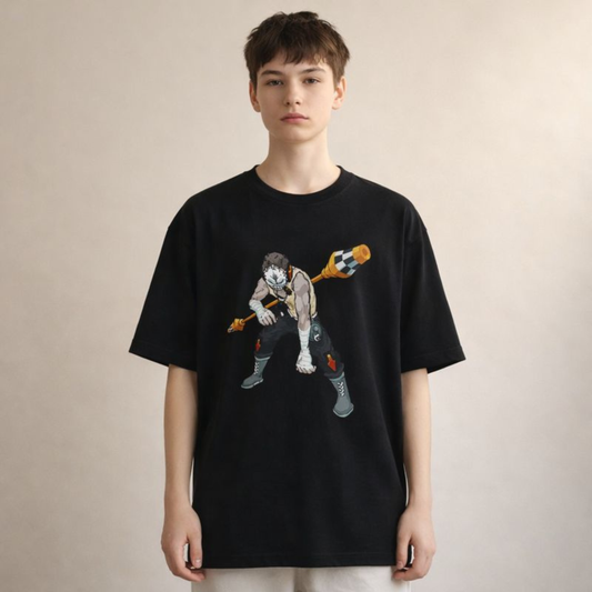 Black oversized unisex streetwear tee featuring a dynamic illustrated character graphic, front view on soft beige studio backdrop