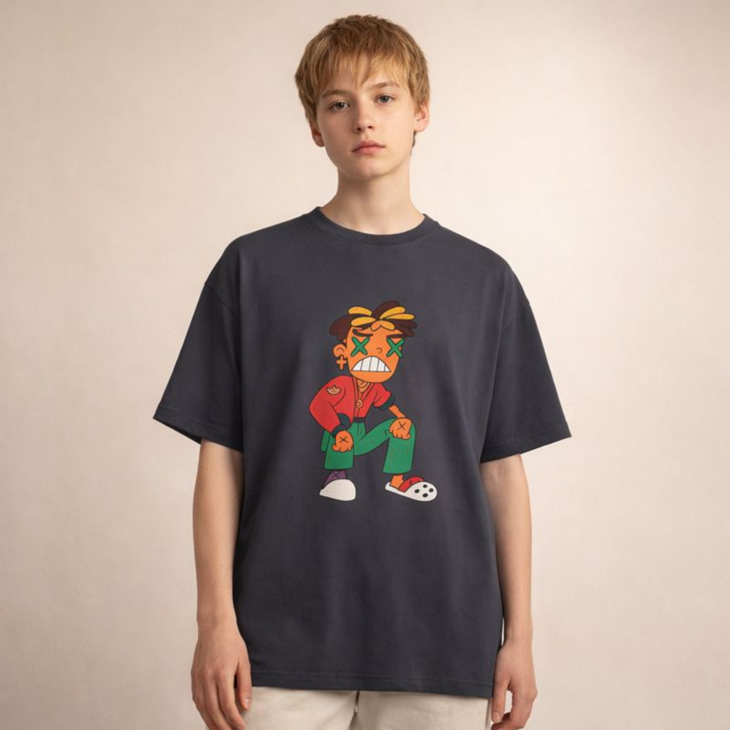 Dark grey oversized unisex t-shirt with bold cartoon graphic, styled on youthful androgynous model in soft studio light