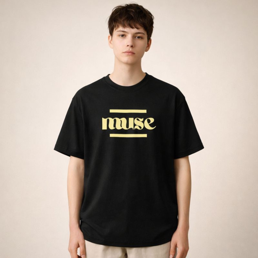 Black unisex oversized streetwear t-shirt featuring minimal muse typography graphic, relaxed fit styled in clean neutral studio