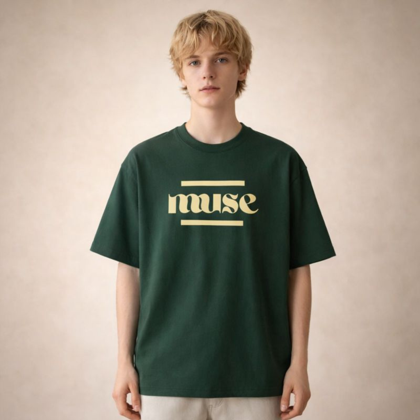 Unisex forest green oversized t-shirt with minimal “muse” typography print, styled front-facing on neutral studio background