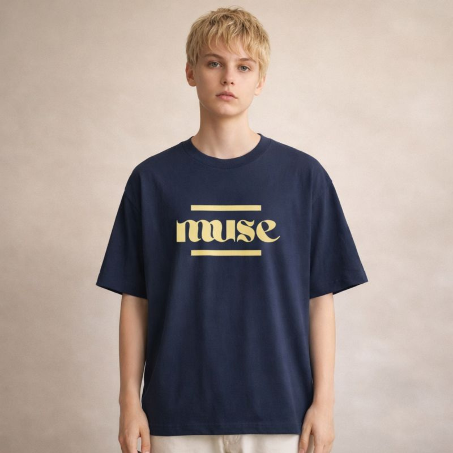 Navy oversized unisex streetwear t-shirt with bold muse lettering, relaxed everyday fit photographed in soft neutral studio